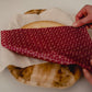 The Cotswold Eco Company Handmade Beeswax Wrap - wrapping an apple pie with a red beeswax wrap